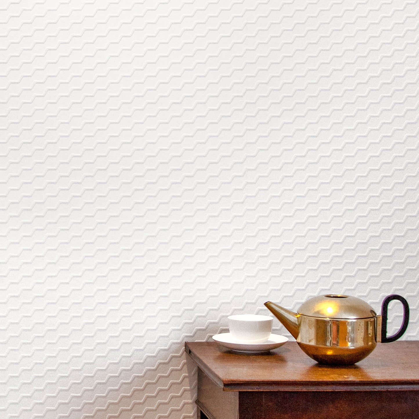 Buzz white flock on white textural wallpaper with brass teapot and white porcelain tea cup