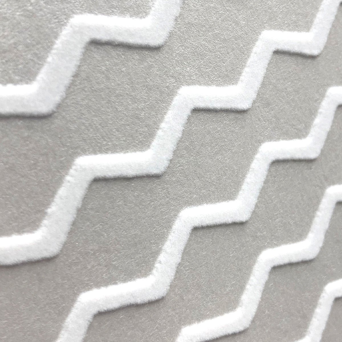 Close up detail of Buzz white flock and silver wallpaper