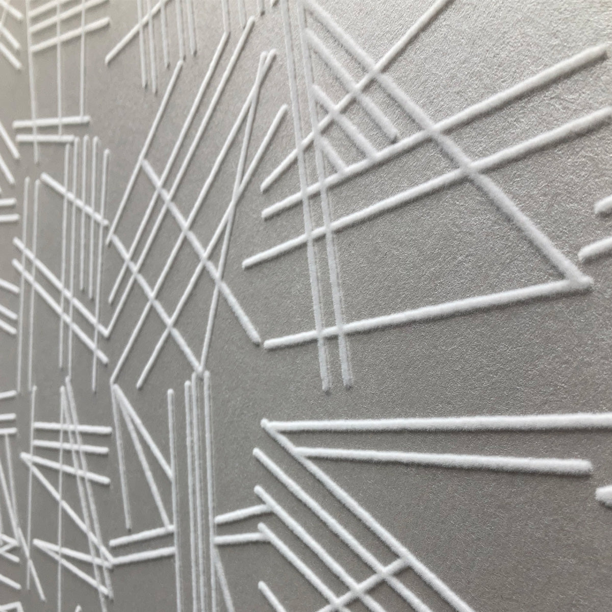 Tilt white flock on silver wallpaper detail close up