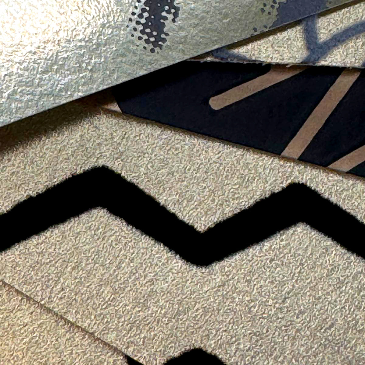 Close up of metallic gold wallpaper samples